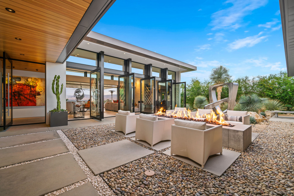 Inspiration for a contemporary courtyard patio in Los Angeles with a fire feature and no cover.