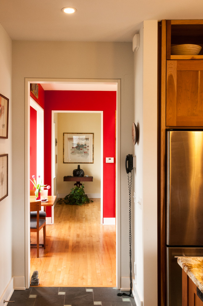 Design ideas for a traditional hallway in Chicago with red walls and light hardwood floors.