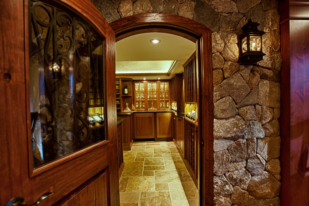 Traditional wine cellar in Boston with travertine floors and storage racks.