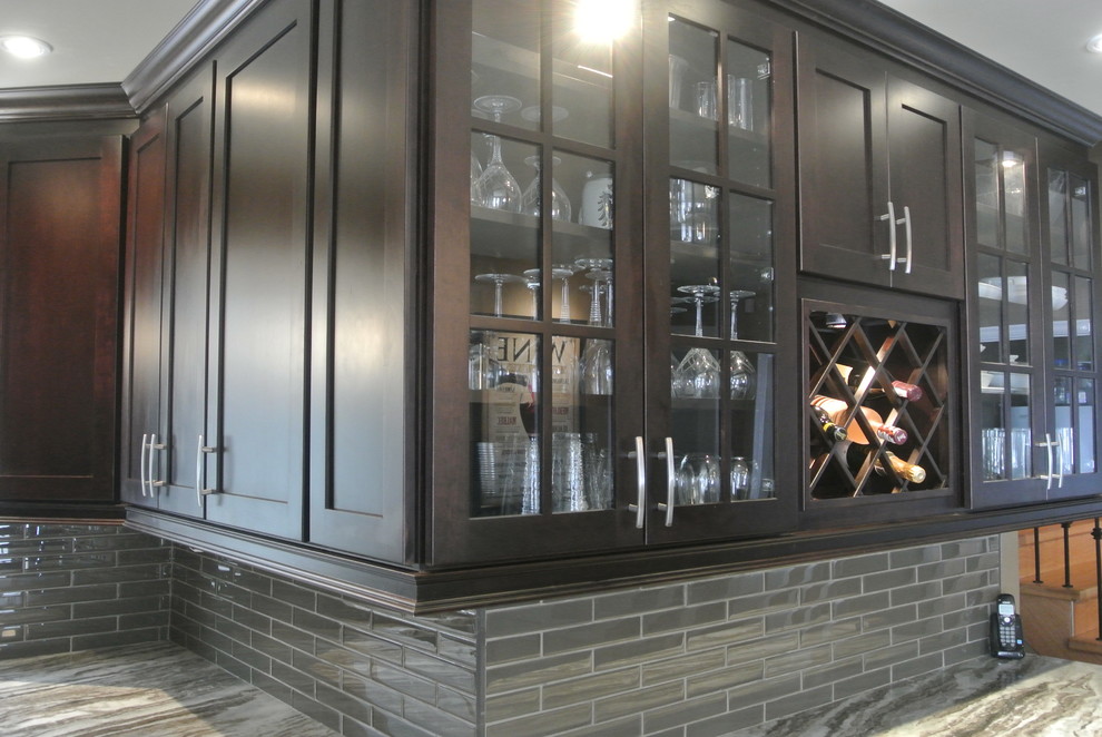 Eat-in kitchen - mid-sized transitional u-shaped eat-in kitchen idea in Toronto with an undermount sink, shaker cabinets, dark wood cabinets, quartzite countertops, stainless steel appliances and an island