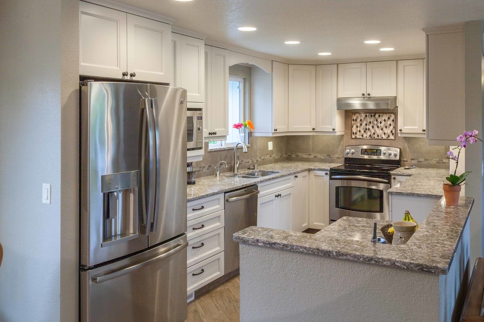 Eat-in kitchen - mid-sized transitional u-shaped porcelain tile eat-in kitchen idea in Seattle with an undermount sink, recessed-panel cabinets, white cabinets, quartz countertops, brown backsplash, ceramic backsplash, stainless steel appliances and no island