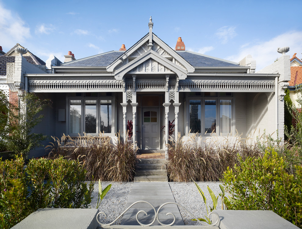 Inspiration for a traditional two-storey grey exterior in Melbourne with wood siding.