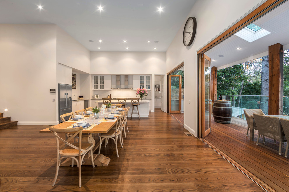 Inspiration for a large country dining room in Melbourne with white walls and medium hardwood floors.