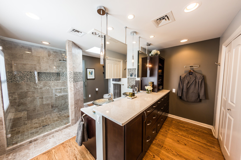 Inspiration for a mid-sized contemporary master bathroom in Other with a vessel sink, flat-panel cabinets, dark wood cabinets, engineered quartz benchtops, an open shower, medium hardwood floors, a one-piece toilet, gray tile, porcelain tile, grey walls, multi-coloured floor and a hinged shower door.