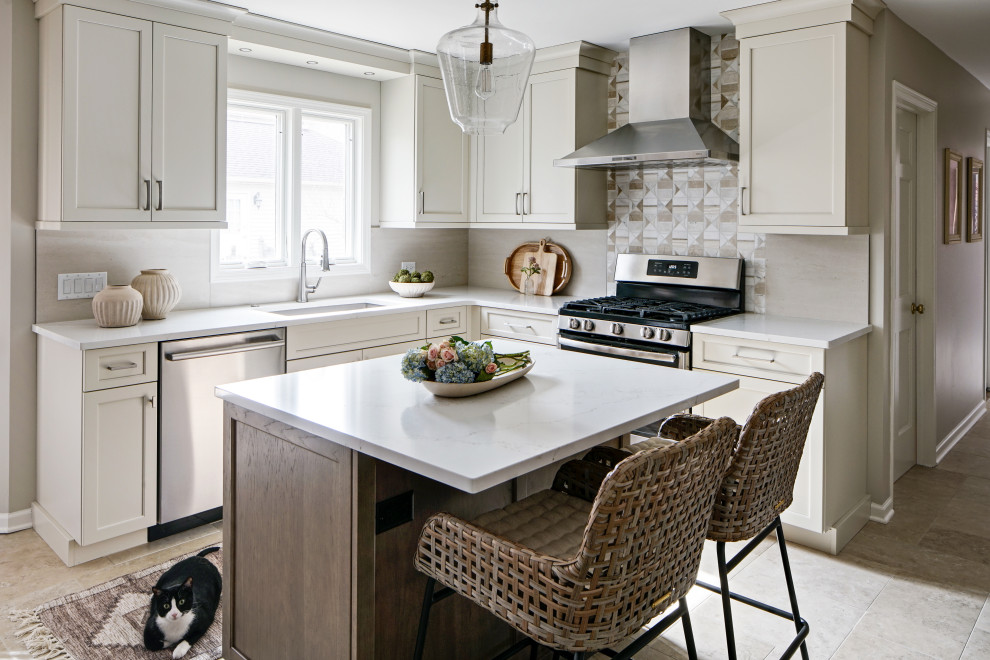 Inspiration for a mid-sized transitional l-shaped ceramic tile and beige floor eat-in kitchen remodel in Chicago with an undermount sink, flat-panel cabinets, beige cabinets, quartz countertops, beige backsplash, ceramic backsplash, stainless steel appliances, an island and white countertops