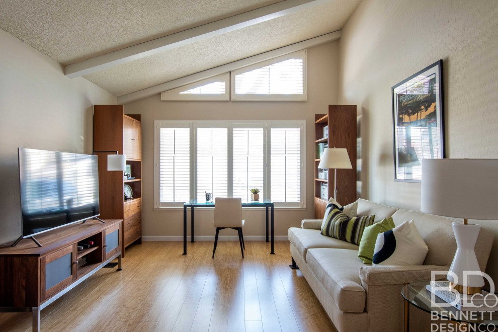Cette photo montre un petit salon tendance ouvert avec un mur beige, parquet clair, un téléviseur indépendant et un plafond voûté.