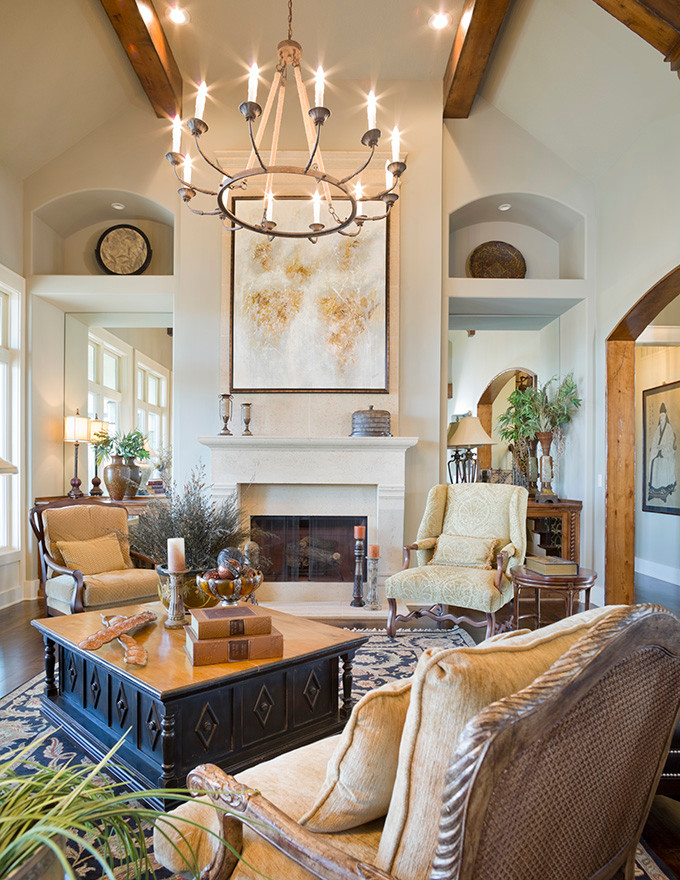 Photo of a large traditional open concept family room in Kansas City with beige walls, dark hardwood floors, a standard fireplace and a stone fireplace surround.