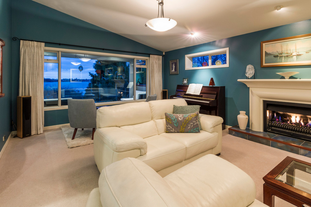 Mid-sized contemporary enclosed family room in Auckland with a music area, blue walls, carpet, a standard fireplace and a plaster fireplace surround.