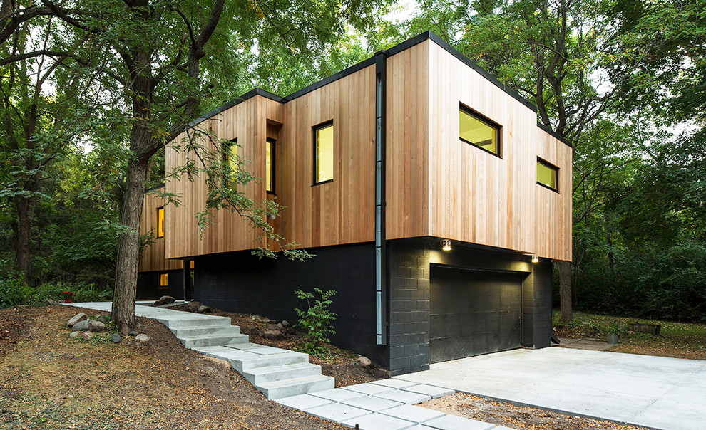 This is an example of a contemporary two-storey exterior in Minneapolis with wood siding and a flat roof.