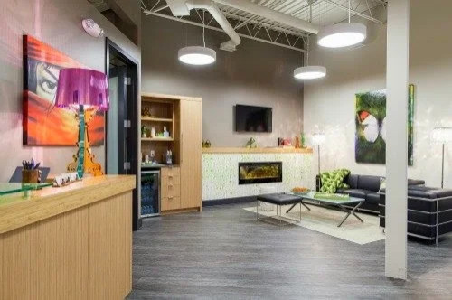 Reception lounge with linear fireplace and custom front desk, Dentistry for Health Omaha