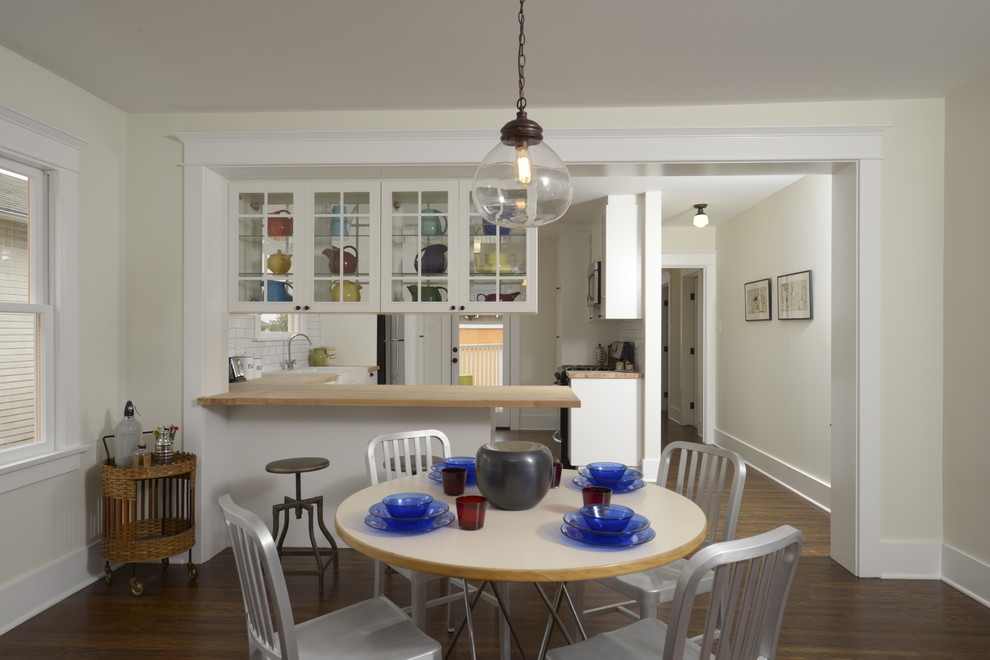 This is an example of a mid-sized arts and crafts kitchen/dining combo in Los Angeles with white walls and dark hardwood floors.