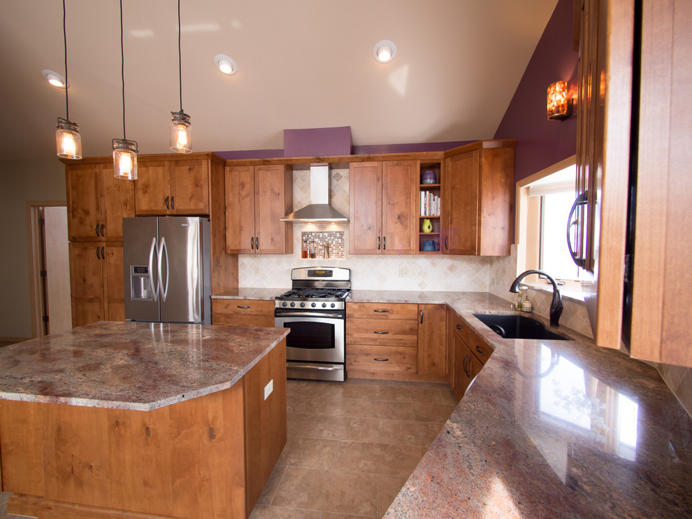 Example of a large arts and crafts l-shaped ceramic tile and beige floor open concept kitchen design in Denver with an undermount sink, shaker cabinets, medium tone wood cabinets, granite countertops, beige backsplash, ceramic backsplash, stainless steel appliances and an island
