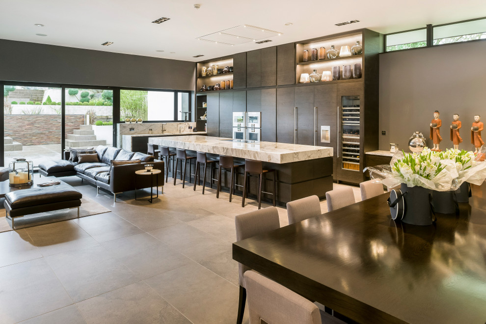 Large contemporary kitchen in Other with a double-bowl sink, flat-panel cabinets, dark wood cabinets, marble worktops, white splashback, marble splashback, stainless steel appliances, porcelain flooring, an island, grey floors and white worktops.