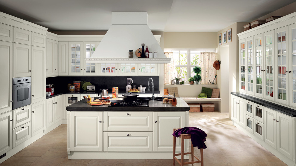 Photo of a large traditional u-shaped eat-in kitchen in Melbourne with an undermount sink, raised-panel cabinets, white cabinets, quartzite benchtops, black splashback, stone slab splashback, stainless steel appliances, ceramic floors and a peninsula.