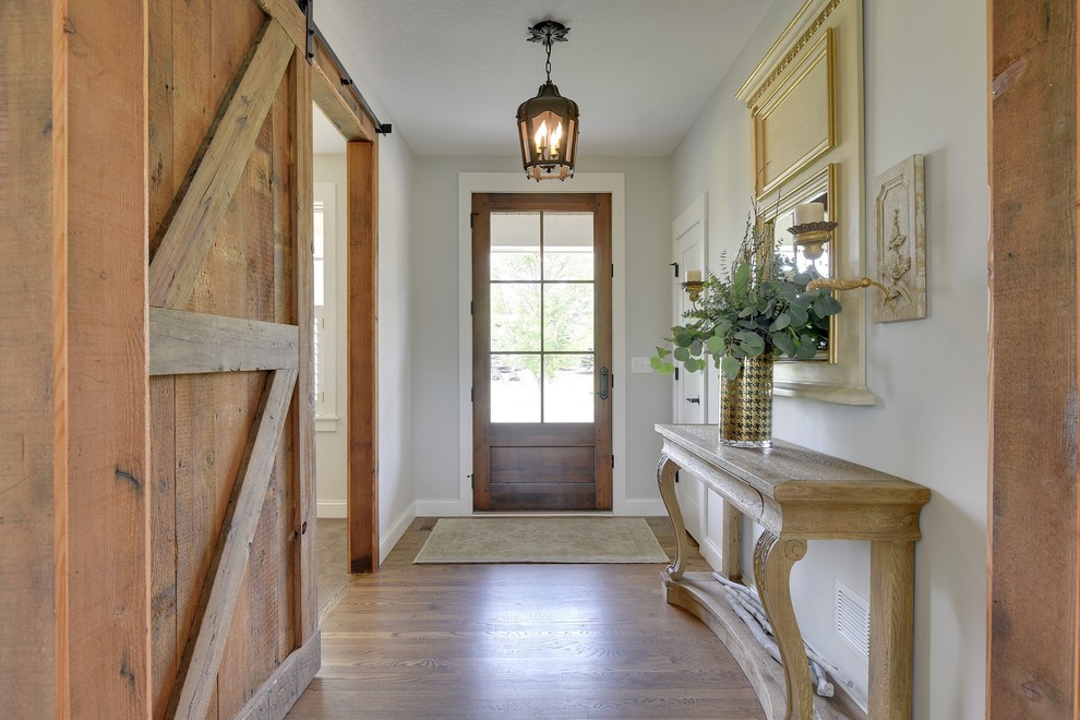 This is an example of a traditional entryway in Minneapolis with dark hardwood floors and a single front door.