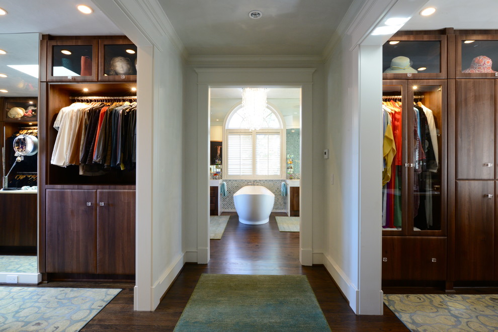 Inspiration for a traditional gender-neutral storage and wardrobe in Dallas with dark wood cabinets.