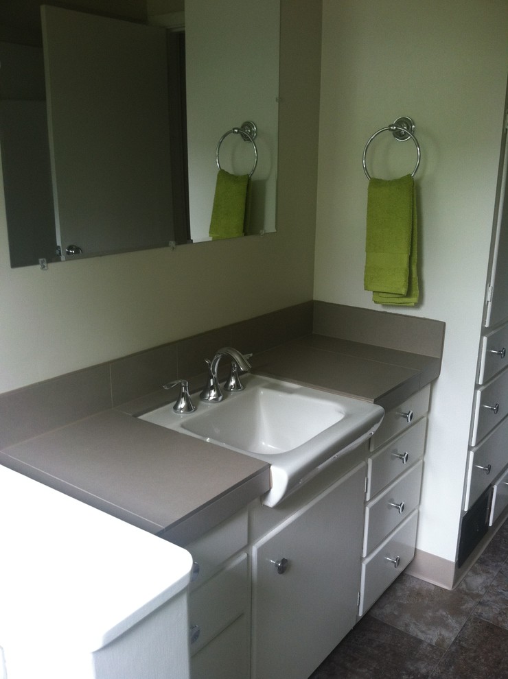 Mid-sized midcentury 3/4 bathroom in Portland with flat-panel cabinets, white cabinets, an alcove shower, a two-piece toilet, gray tile, ceramic tile, white walls, vinyl floors, a console sink and tile benchtops.