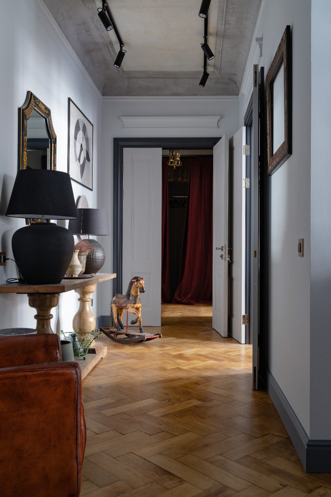 Mid-sized eclectic hallway in Saint Petersburg with grey walls, medium hardwood floors and brown floor.