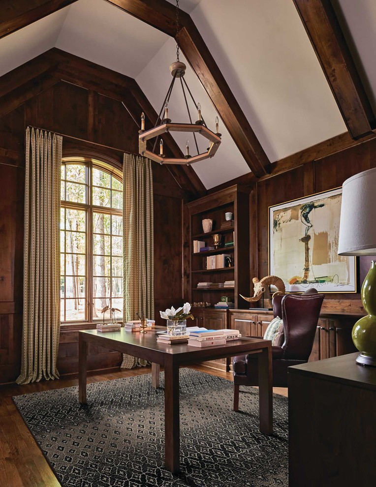 Photo of a mid-sized arts and crafts home office in St Louis with brown walls, dark hardwood floors, a freestanding desk and brown floor.