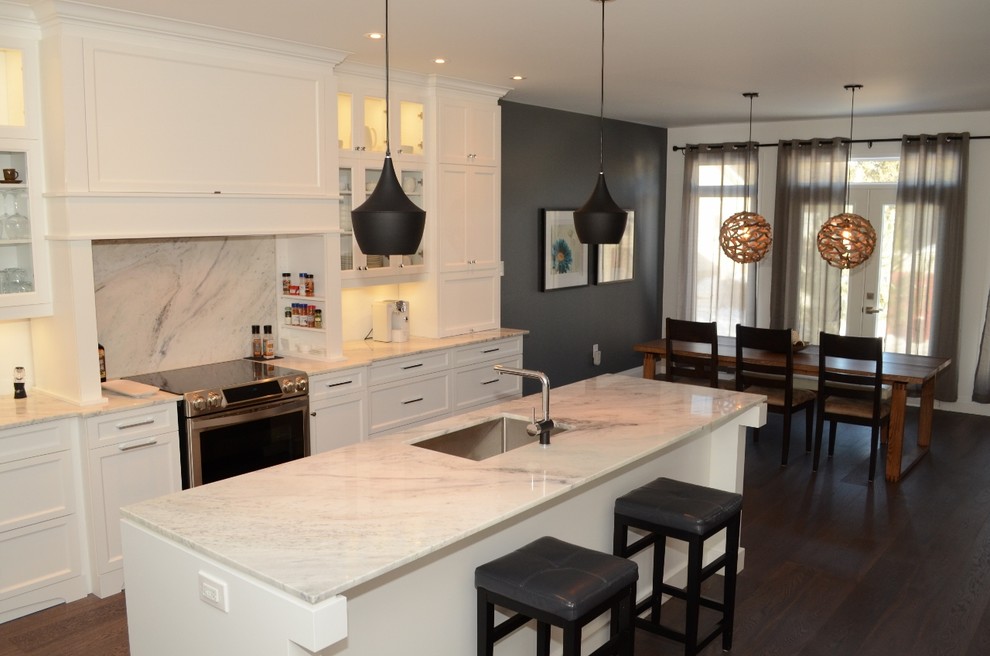 Inspiration for a mid-sized transitional single-wall eat-in kitchen remodel in Toronto with recessed-panel cabinets, white cabinets, stainless steel appliances and an island