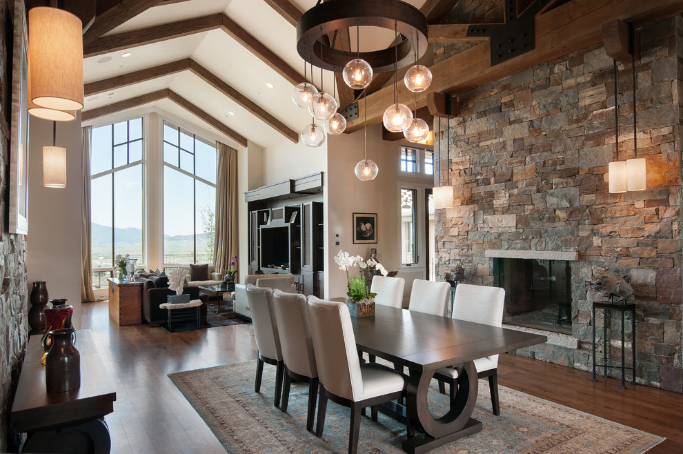 Photo of a contemporary open plan dining in Salt Lake City with medium hardwood floors, a standard fireplace and a stone fireplace surround.