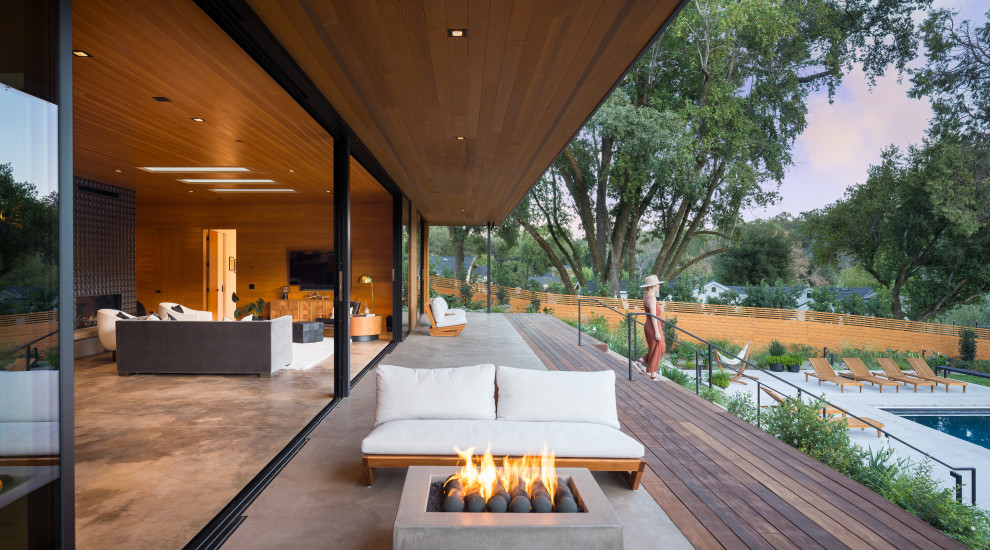 Photo of a medium sized midcentury back terrace in San Francisco with a fire feature.