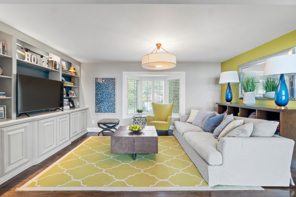Photo of a small beach style open concept family room in Baltimore with a game room, green walls, carpet, a built-in media wall and green floor.