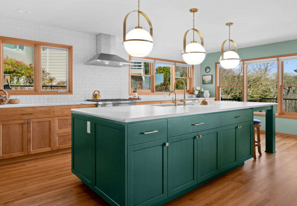 Inspiration for a transitional l-shaped medium tone wood floor kitchen remodel with shaker cabinets, white backsplash, an island and white countertops