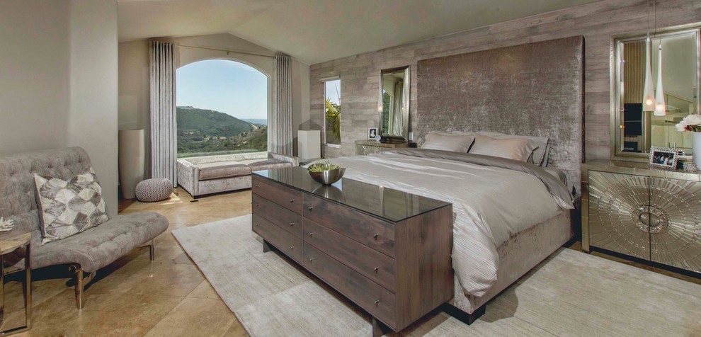 Photo of a large contemporary master bedroom in San Diego with beige walls and travertine floors.