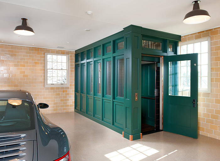 Inspiration for a large transitional attached three-car garage in Other.