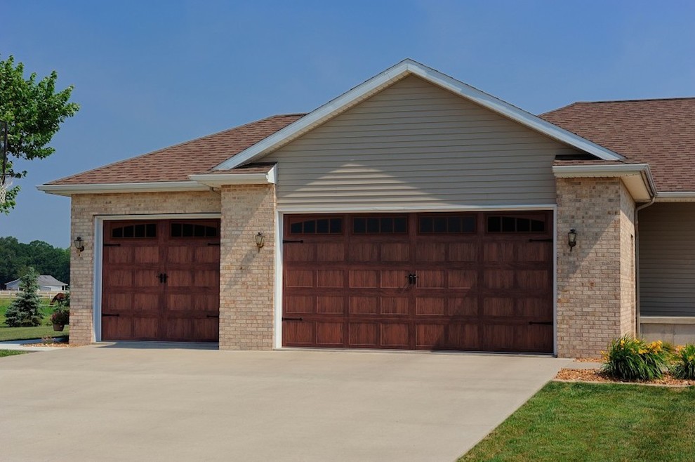 Photo of a large transitional attached three-car garage in New York.