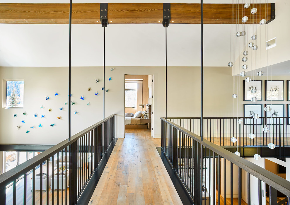 Grand Lake Home - Example of a mountain style light wood floor hallway design in Denver with beige walls