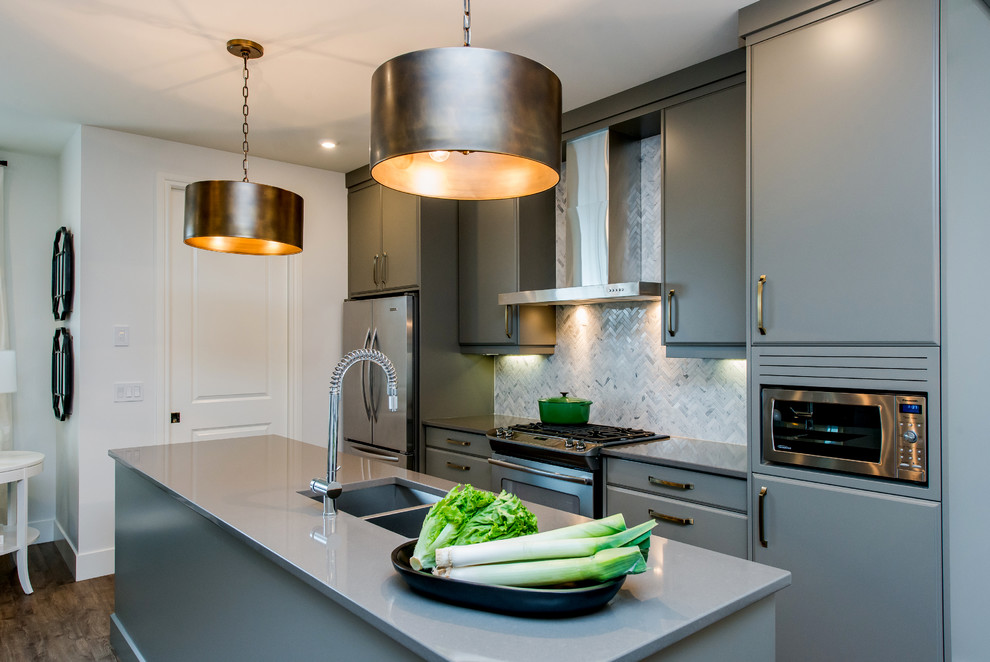 Example of a mid-sized transitional dark wood floor eat-in kitchen design in Calgary with an undermount sink, flat-panel cabinets, gray cabinets, quartz countertops, multicolored backsplash, mosaic tile backsplash, stainless steel appliances and an island