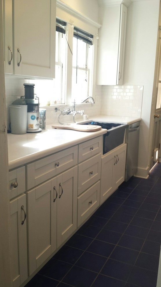 This is an example of a small traditional galley eat-in kitchen in Los Angeles with a farmhouse sink, shaker cabinets, white cabinets, quartzite benchtops, white splashback, subway tile splashback, stainless steel appliances, ceramic floors, no island, blue floor and white benchtop.