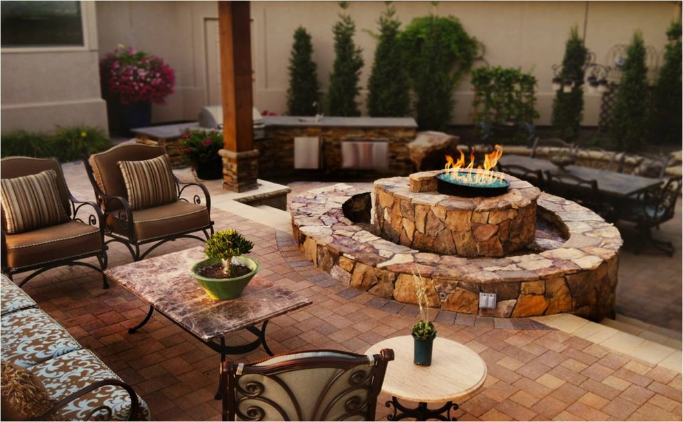 Design ideas for a mid-sized eclectic backyard patio in Boise with a fire feature, concrete pavers and no cover.