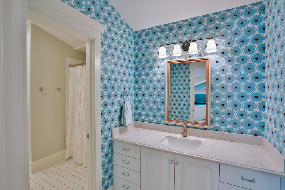 This is an example of a large transitional kids bathroom in Salt Lake City with an undermount sink, recessed-panel cabinets, white cabinets, white tile, blue walls, quartzite benchtops, mosaic tile floors, a drop-in tub and a shower/bathtub combo.