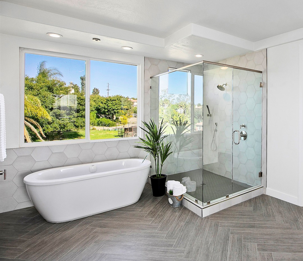 Inspiration for a large country master bathroom in San Diego with shaker cabinets, grey cabinets, a freestanding tub, a corner shower, white tile, porcelain tile, white walls, porcelain floors, an undermount sink, quartzite benchtops, grey floor, a hinged shower door and multi-coloured benchtops.