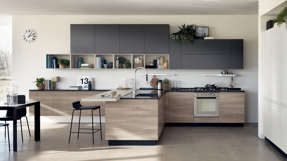 Mid-sized modern l-shaped eat-in kitchen in Melbourne with a single-bowl sink, raised-panel cabinets, black cabinets, quartz benchtops, light hardwood floors and multiple islands.