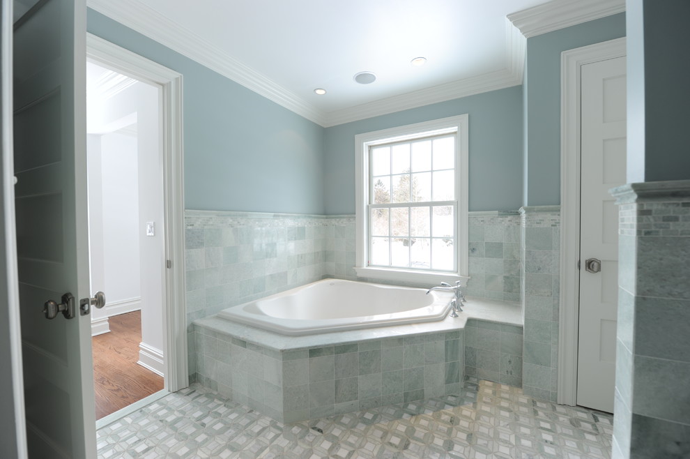 Inspiration for an expansive traditional master bathroom in New York with an undermount sink, raised-panel cabinets, white cabinets, marble benchtops, a corner tub, an alcove shower, a two-piece toilet, green tile, stone tile, green walls and marble floors.