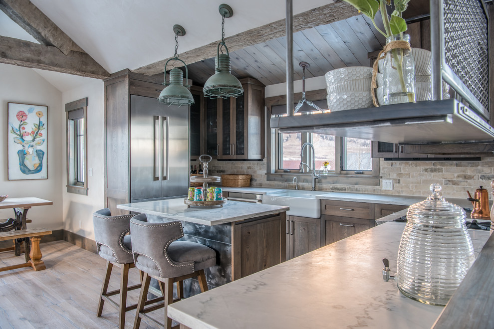 Inspiration for a country kitchen in Denver with a farmhouse sink, shaker cabinets, medium wood cabinets, brick splashback, stainless steel appliances, light hardwood floors and with island.