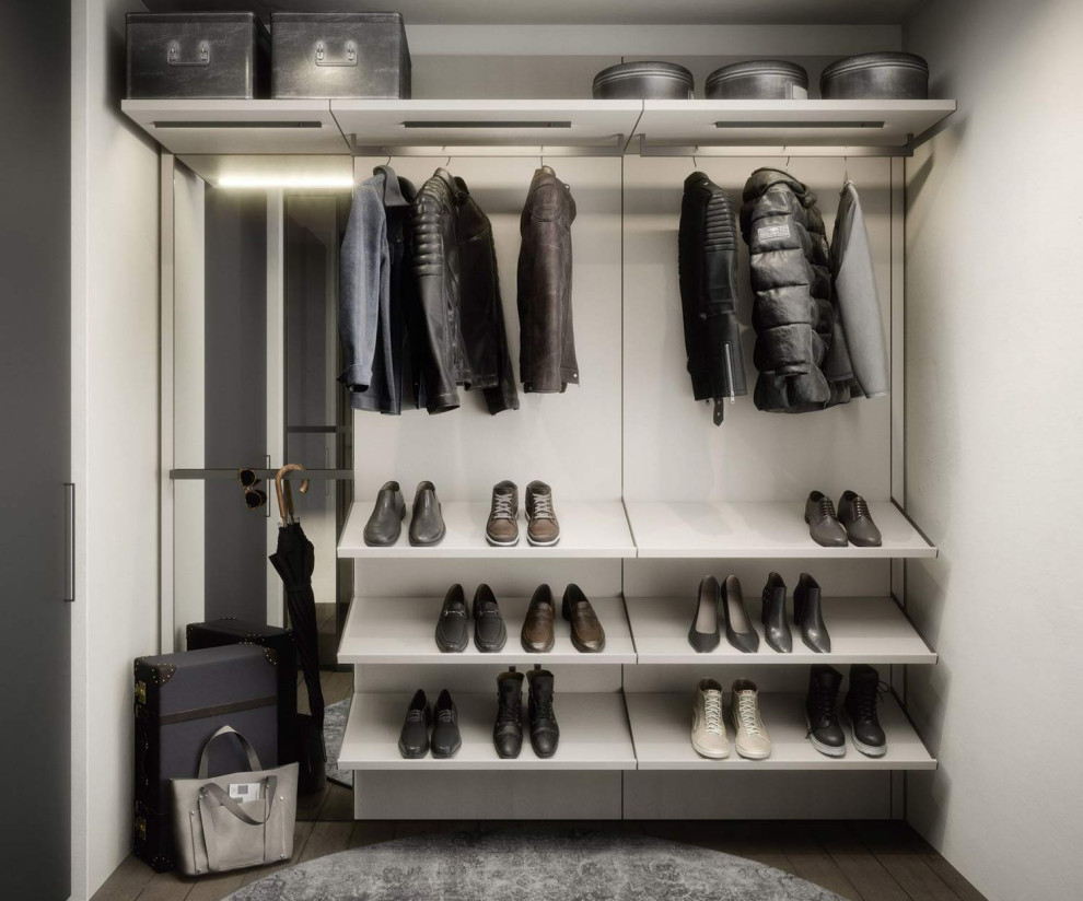 Small modern gender neutral walk-in wardrobe in Munich with open cabinets.