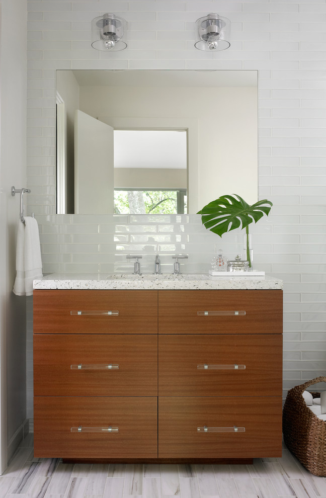 Mid-sized modern master bathroom in Atlanta with an undermount sink, flat-panel cabinets, medium wood cabinets, white tile, glass tile, beige walls and marble floors.