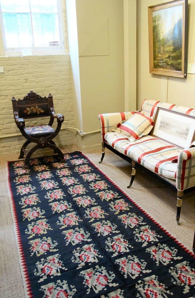 This is an example of a large traditional hallway in San Francisco with beige walls and carpet.
