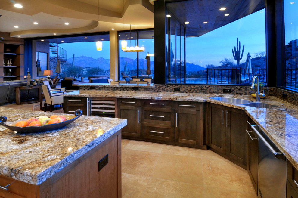 Photo of a large contemporary u-shaped open plan kitchen in Phoenix with a double-bowl sink, shaker cabinets, dark wood cabinets, granite benchtops, window splashback, stainless steel appliances, limestone floors, with island and beige floor.