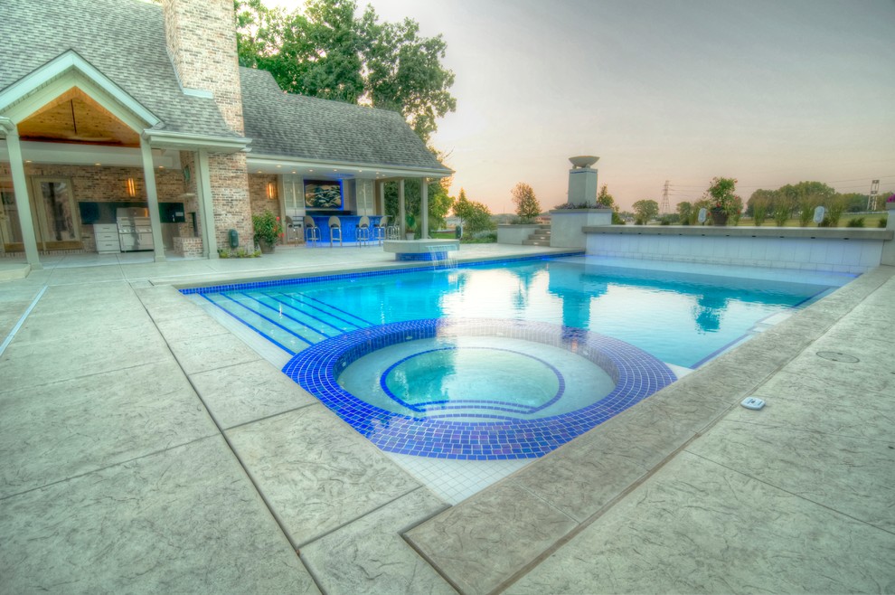 Inspiration for a large transitional backyard concrete paver and rectangular natural hot tub remodel in Cedar Rapids