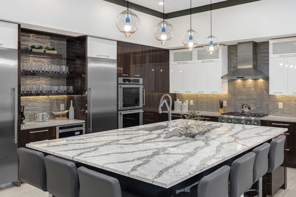 Design ideas for a large modern u-shaped open plan kitchen in Orlando with stainless steel appliances, with island, a drop-in sink, flat-panel cabinets, dark wood cabinets, quartz benchtops, metallic splashback, glass tile splashback and porcelain floors.