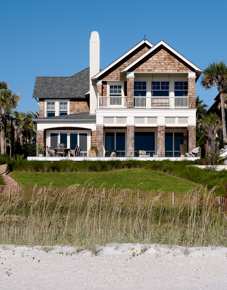This is an example of a beach style two-storey exterior in Jacksonville with wood siding and a gable roof.
