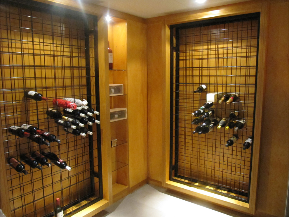 Design ideas for a mid-sized industrial wine cellar in Sydney with ceramic floors and display racks.
