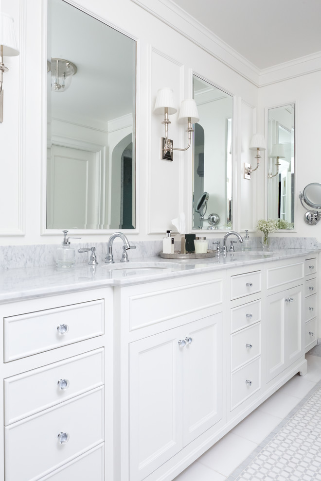 Inspiration for a mid-sized traditional master bathroom in Chicago with raised-panel cabinets, white cabinets, a freestanding tub, a corner shower, a one-piece toilet, white tile, marble, white walls, marble floors, a drop-in sink and granite benchtops.