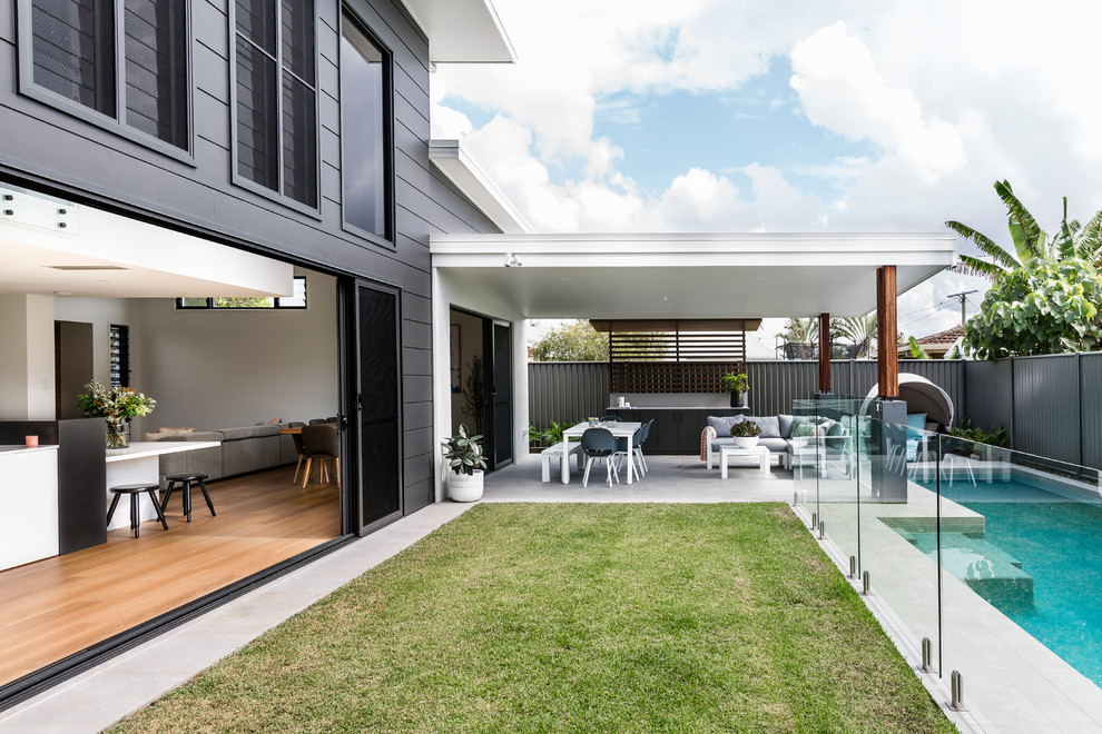 Design ideas for a contemporary two-storey grey exterior in Sunshine Coast with mixed siding and a flat roof.